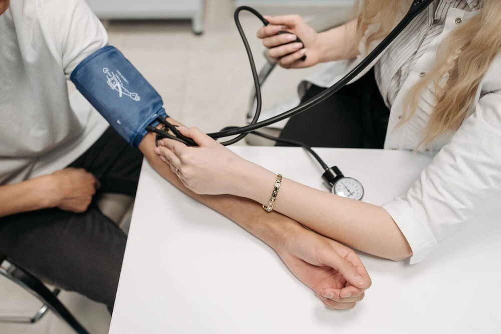doctor checking blood pressure