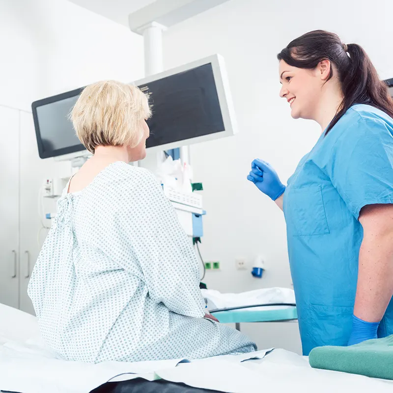 Nurse explaining procedure to patient in hospital surgery